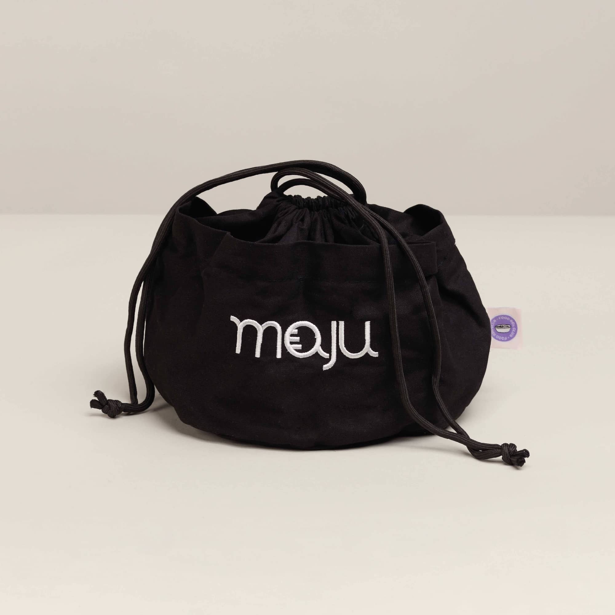 Vue du dessus du sac de transport maju en coton et de couleur noir. 